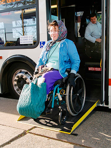 Photo of rider in wheelchair exiting the bus using the ramp